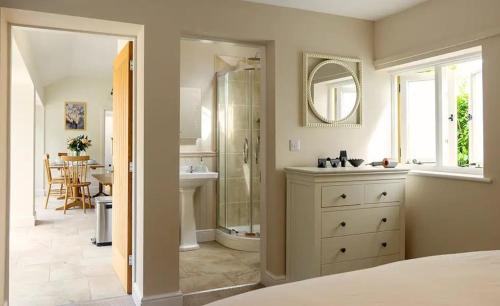 a bathroom with a shower and a sink and a mirror at Bluebell in Edlington