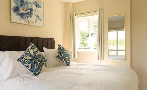 a bedroom with a white bed with a window at Bluebell in Edlington
