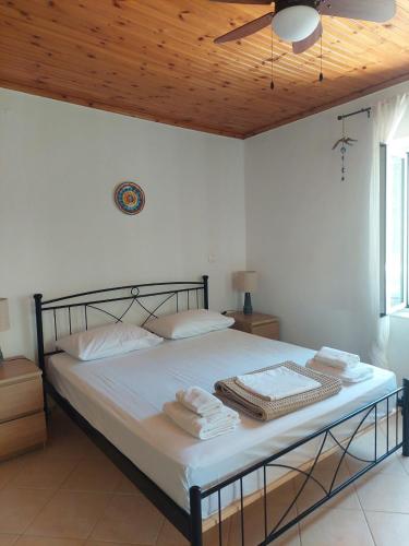 a bedroom with a bed with towels on it at Marialena's houses in Methoni