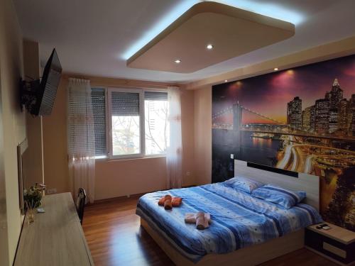 a bedroom with a bed with two stuffed animals on it at Charming Apartment with balcony in Vidin