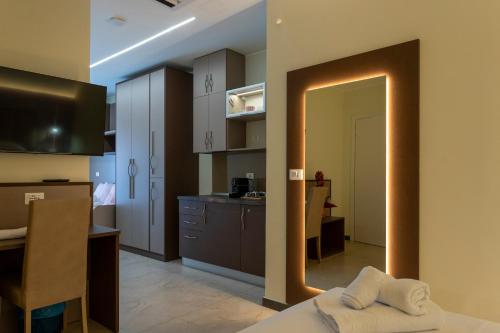 a room with a kitchen and a dining room at The Reserve by Vulcano in Mirto