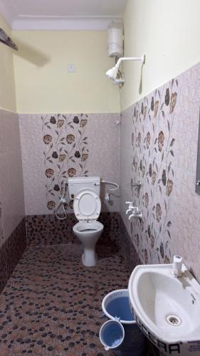 a bathroom with a toilet and a sink at Hotel Golden Pearl in Rewa