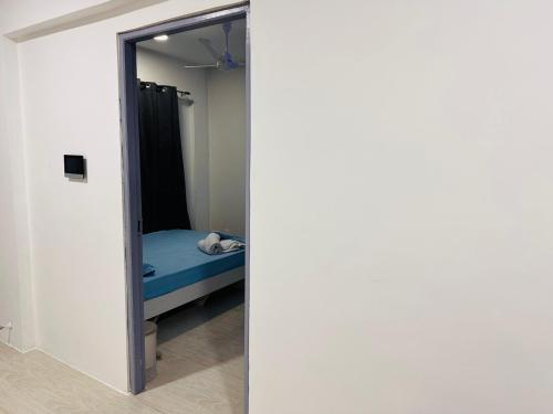 a room with a mirror and a bed in it at Twice Apartment in Hulhumale