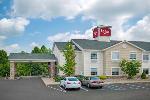 a hotel with cars parked in a parking lot at Red Roof Inn Charlestown in Charlestown