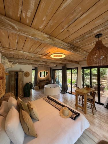 a large bedroom with a large bed and a table at LA PAUSE Chisà in Chisa