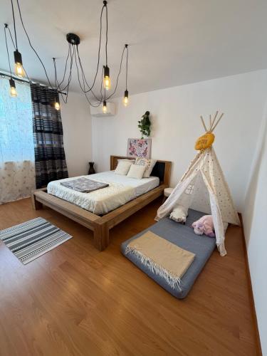a bedroom with two beds and a play tent at Harmony House Vera Lux in Dragomireşti