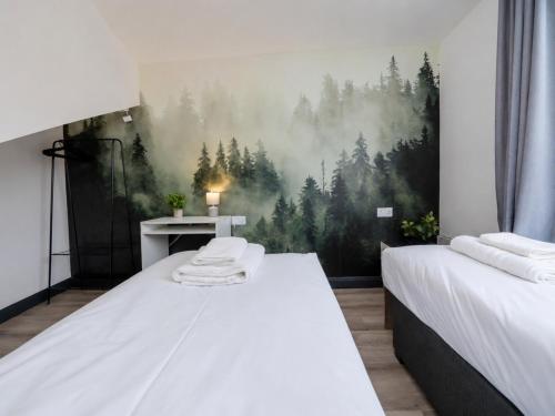 two beds in a room with a painting on the wall at Family & Group House | 3 Baths | Sleeps 12 in Banbury