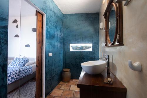 a bathroom with a sink and a mirror at Tabaiba Suites Lanzarote - Macaronesia Homes in La Asomada