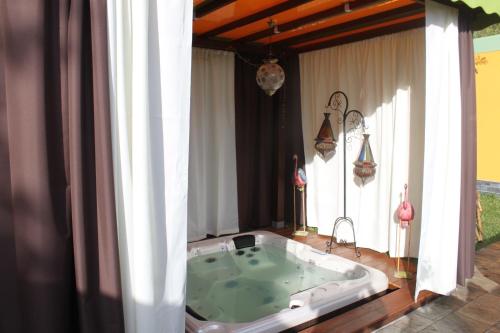 a jacuzzi tub in the middle of a room at Chez Dolores in Le Bois de Nèfles
