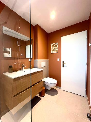 a bathroom with a toilet and a sink at La Villa d'Aix - Entre lacs et montagne - Jacuzzi in Saint-Ours
