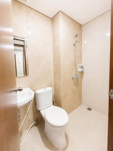 a bathroom with a toilet and a sink at Transpark Cibubur by 21room in Kalimanggis