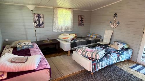 a room with two beds and a couch at Peipsi Village Sofia in Kasepää