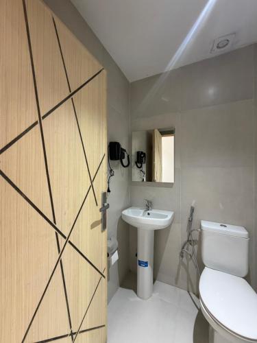 a bathroom with a toilet and a sink at Nezha Hotel in Tangier