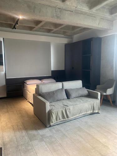 a living room with a couch and two beds at FLAT Executivo próx Consulado Americano in Recife