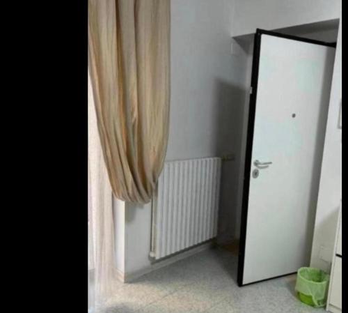 a mirror next to a door with a curtain at Spina home in Vieste