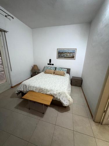 a bedroom with a bed and a table in it at Casa sole Sicilia in Alcamo