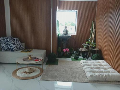 a living room with a couch and a table at Sunrise Bay Villa in Mahébourg