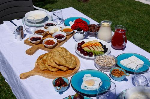 a table with food on a white table cloth at Agroturizem Bylis in Hekal