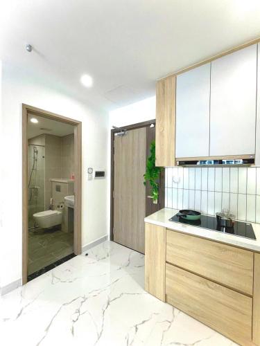 a bathroom with a sink and a toilet in a room at Toà gh6 in Gò Công