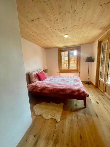 a bedroom with a bed in the corner of a room at Chalet Floriana in Les Diablerets