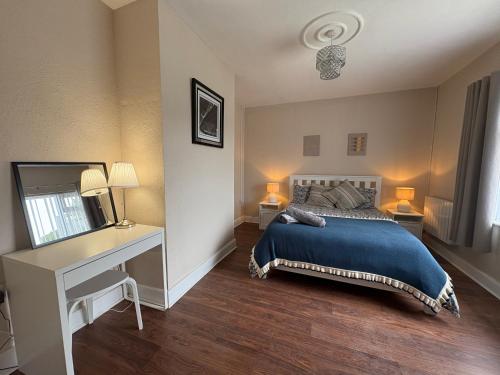 a bedroom with a bed and a desk at Teach Duff in Clonmany
