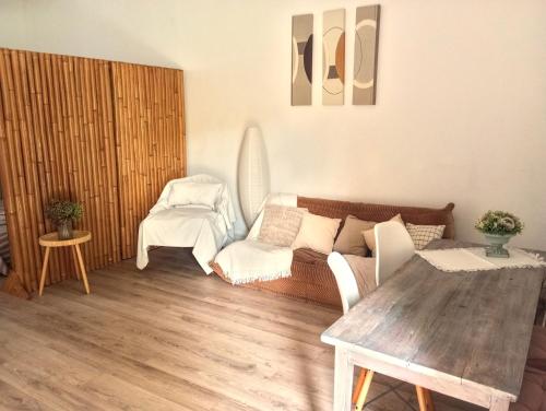 a living room with a couch and a table at Le havre du voyageur in Charly