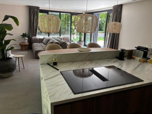a living room with a table and a couch at Prinsenhof 10 - Ouddorp in Ouddorp