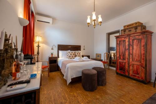 a bedroom with a large bed and a dresser at La Belle Hélène de Ménélas 1862 in Mykines