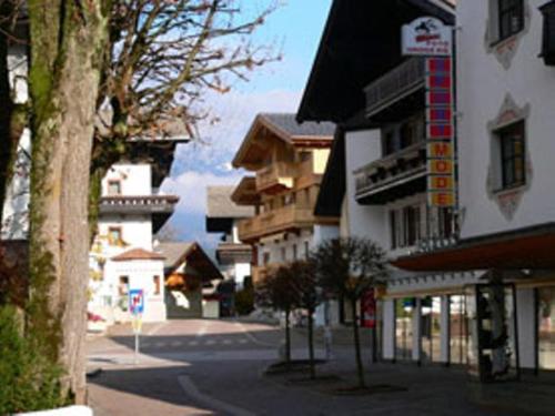 an empty street in a small town with buildings at Dorfappartements Söll in Söll