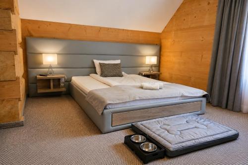 a bedroom with a large bed with two towels on it at Tatrzański Bór Apartamenty in Małe Ciche