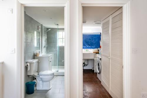 a bathroom with a toilet and a sink at Flint Cottage, Brancaster in Brancaster
