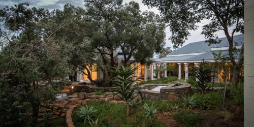 a house with a garden in front of it at The Royal Fischer Hotel in Bloemfontein