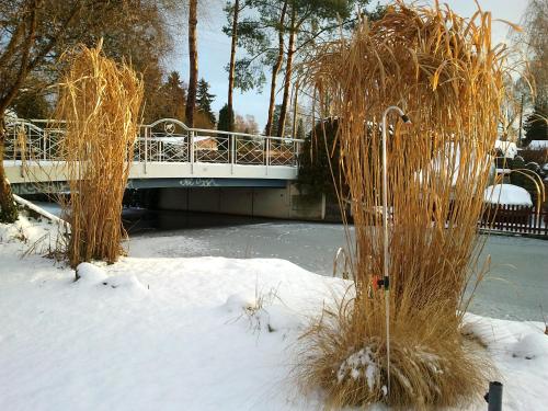 a bridge over a body of water with snow at Pension an der Elsterbrücke in Berlin