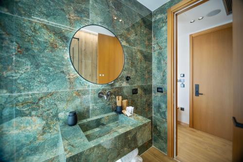 a bathroom with a shower with a mirror at Hotel Potami in Himare