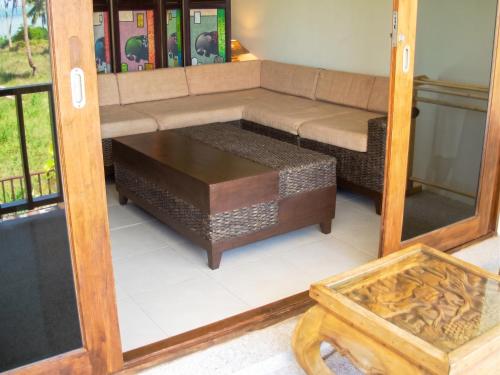 a living room with a couch and a table at Cozy apartment in Ko Samui 64 m² with shared pool in Thong Son Beach