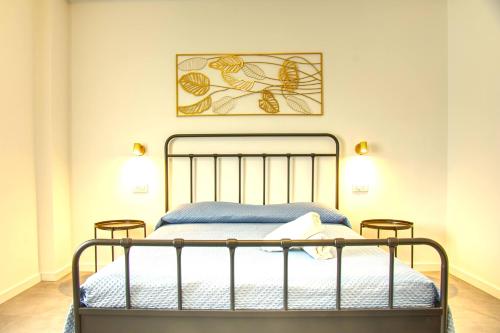 a bedroom with a metal bed with two stools at Casa Alice in Numana