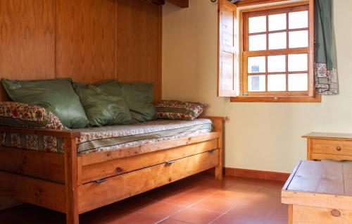 a room with a wooden bed with a window at Cosy Apartment Seia 25 m² Fireplace in Seia