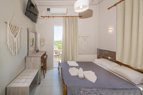 a bedroom with a bed with white towels on it at Bikakis Family Apartments in Kissamos