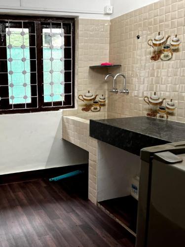 a kitchen with a sink and a counter top at Nature View Friends Villa - The Dream Stays ll Infinity Big pool ll 3Rooms ll Wi-Fi in Lonavala