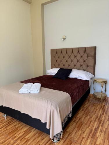 a bedroom with a bed with two towels on it at 4-Bedroom Apartment in Quillabamba