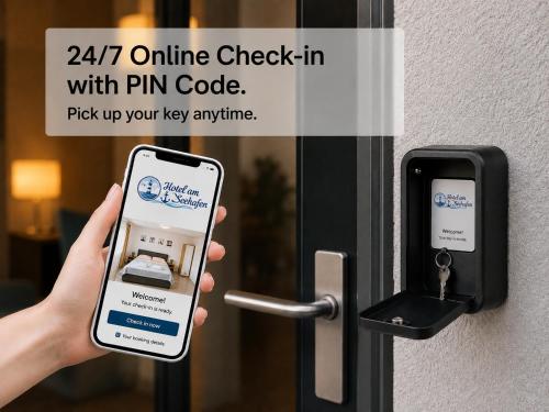 a person holding a cell phone in front of a unlock door at Hotel am Seehafen in Hamburg