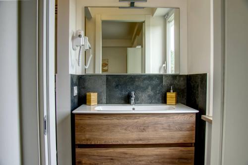 a bathroom with a sink and a mirror at Casa Alice in Numana