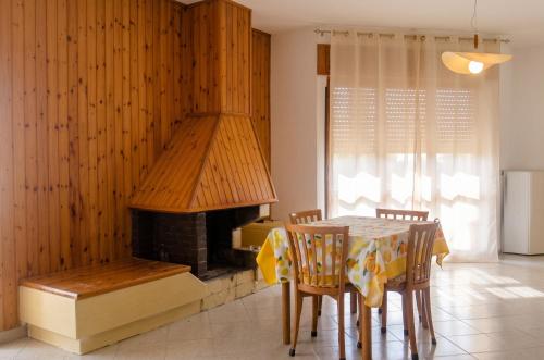 a dining room with a table and a fireplace at Charming Apartment in Velina, 90 m², Mountain View in Castelnuovo Cilento