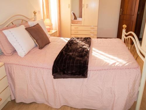 a bed with a blanket and pillows on it at Charming Apartment in Alvoco da Serra - Mountain View - 50 sqm in Alvoco da Serra