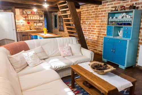 a living room with a white couch and a blue cabinet at Elegant villa with jacuzzi near Možđenec in Možđenec
