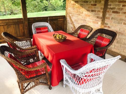 a table with chairs and a bowl of fruit on it at Elegant villa with jacuzzi near Možđenec in Možđenec