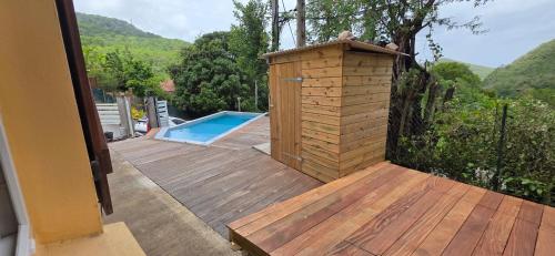 a wooden deck with a small wooden plunge pool at Villa Tidodo in Les Anses-dʼArlets