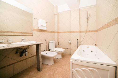a bathroom with a toilet and a tub and a sink at Accommodation Dolcino in Ulcinj