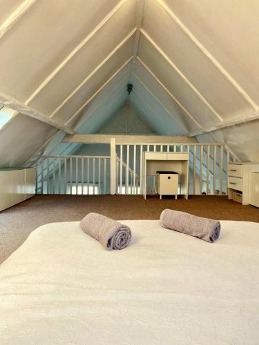 a large white bed with two pillows in a room at Serenity Heights in Westgate-on-Sea