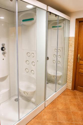 a shower with glass doors in a bathroom at Hotel Rural El Verdenal in Noceda del Bierzo